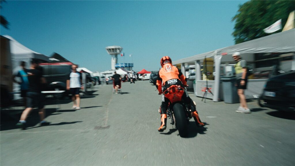 Geoffroy Dehaye quittant les stands à moto sur le Circuit Carole